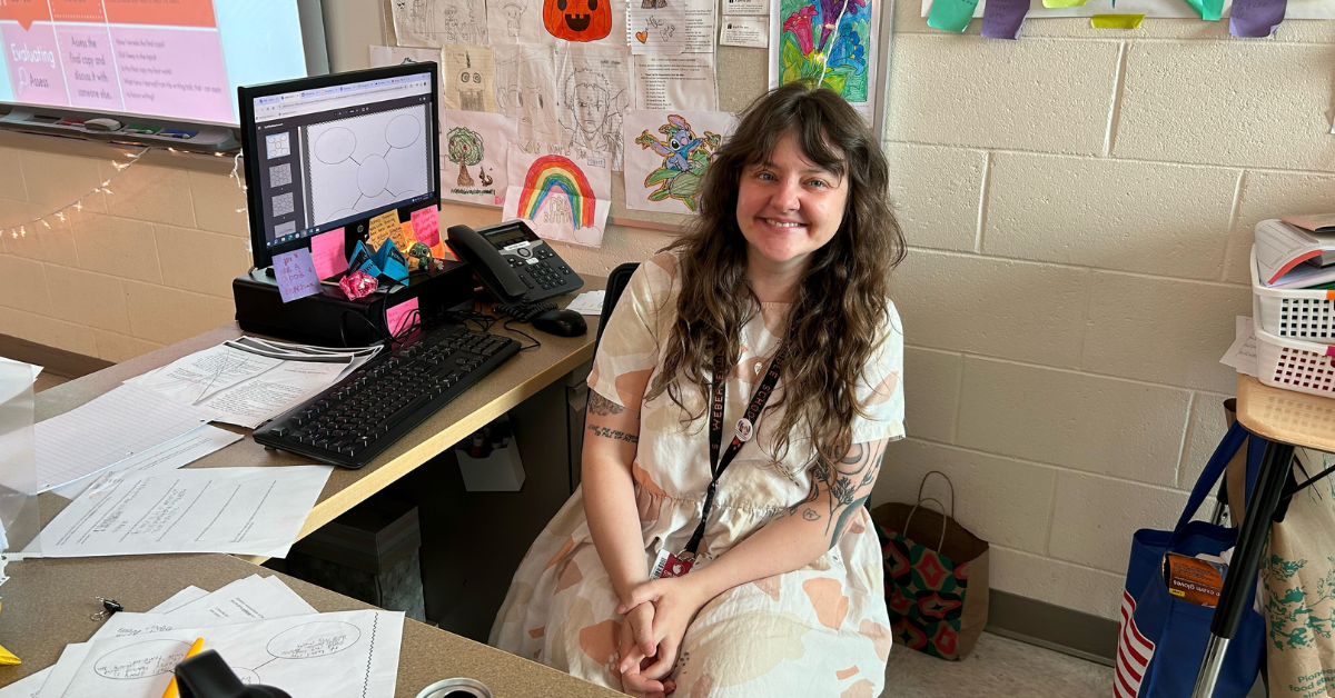 woman sitting at desk smiling